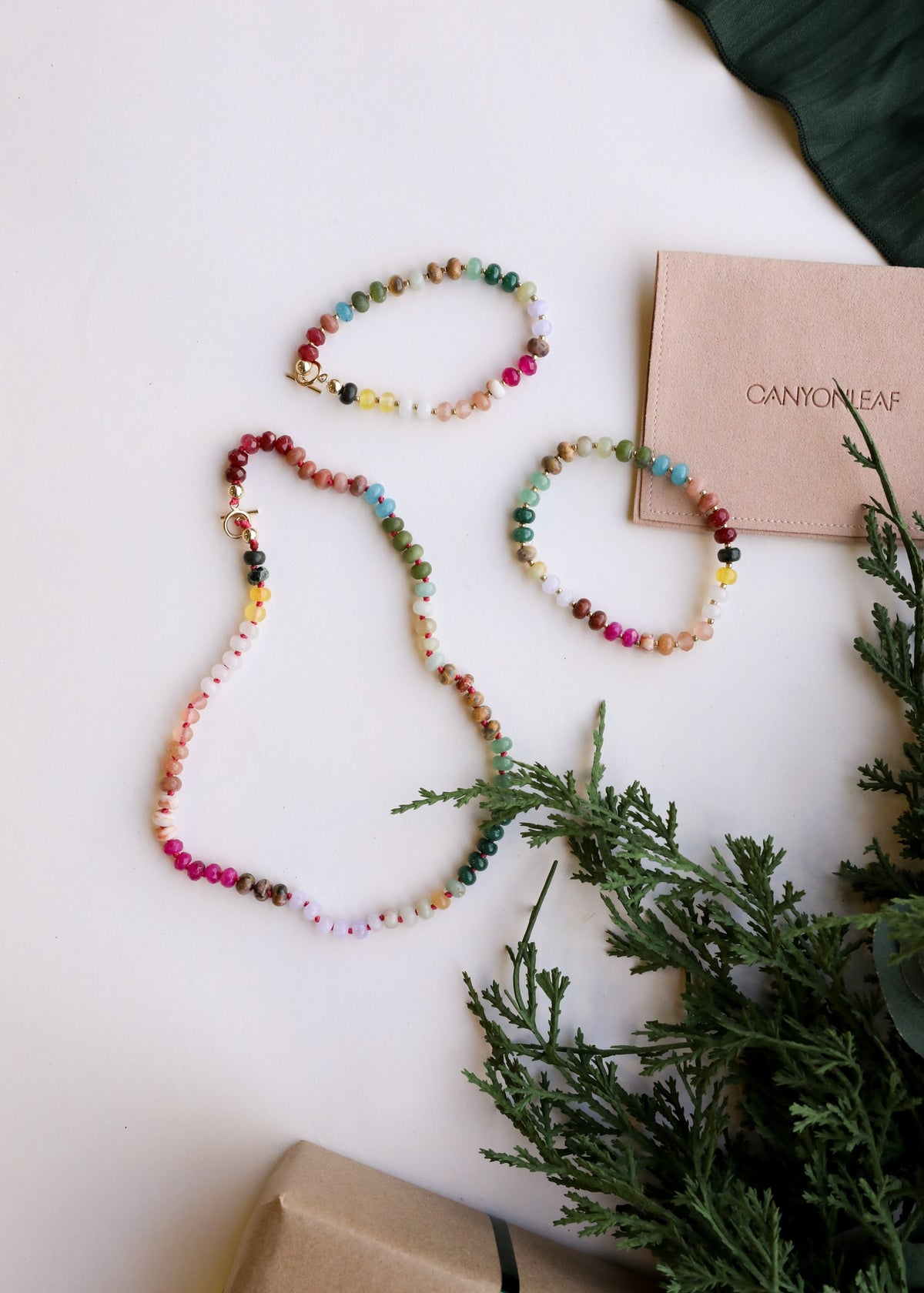 Multi-color gemstone beaded necklace and bracelets set, shown with a gift card.