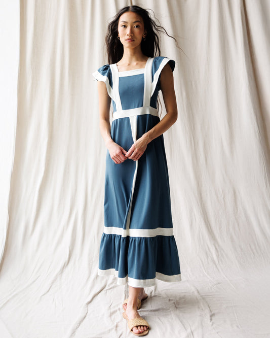 Women’s Block Party dress front view in blue with white trim and hooded cape sleeves