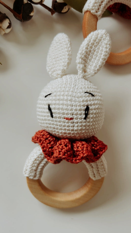 Bunny rattle teether: crocheted white bunny face with orange scarf and wooden ring