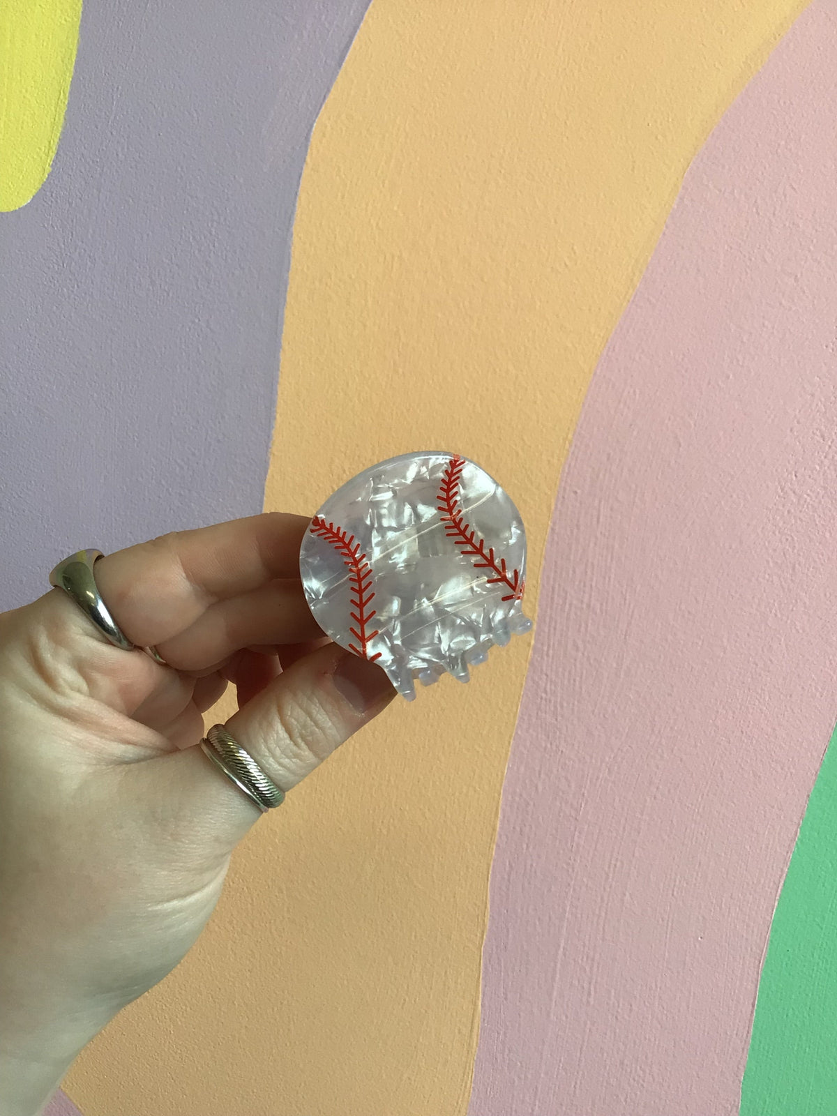Clear baseball-style hair claw clip with red stitch details