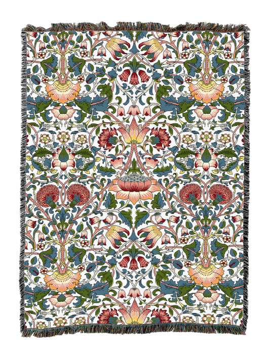 Blanket with cream background, multicolor floral vine print, tassel fringe border.