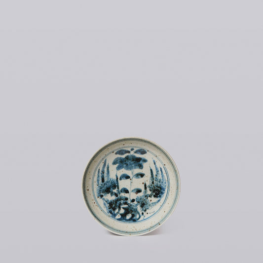 Small round porcelain dish with blue-and-white floral bouquet motif, front view