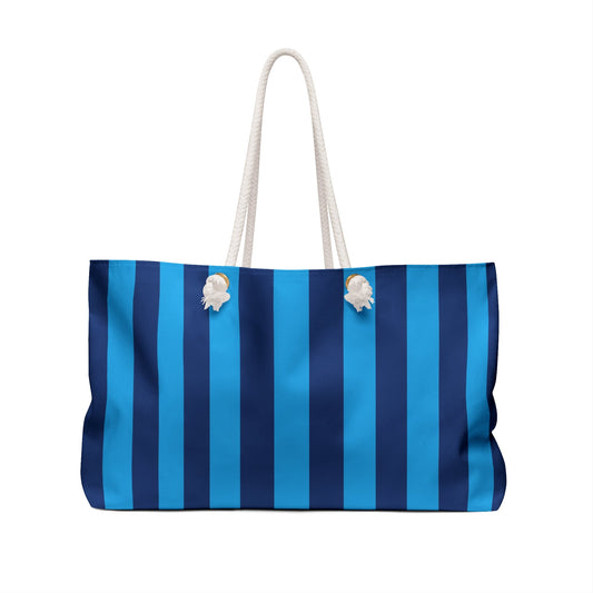 Blue and white striped weekender bag with rope handles and floral charms