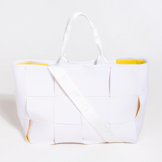 White structured tote bag with yellow lining and long shoulder strap, top handles