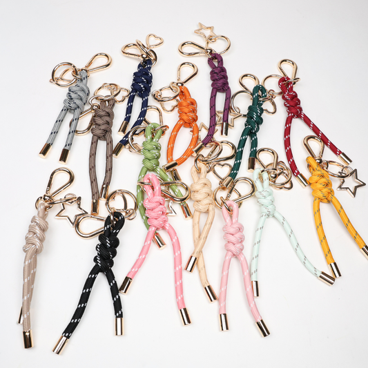 Assorted paracord key chains with gold-tone clasps in multiple colors