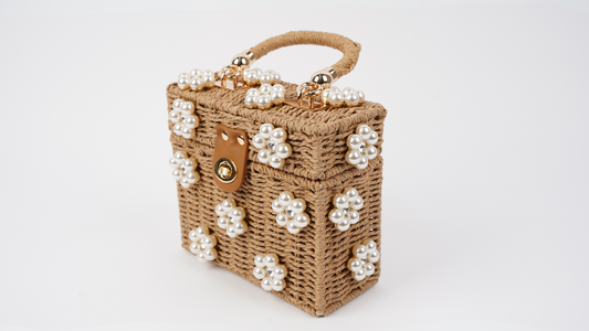 Raffia mini handbag with pearl flower accents, gold clasp and handle detail