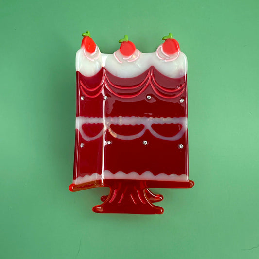 Red and white cake hair clip with three cherry candle caps and glossy detailing