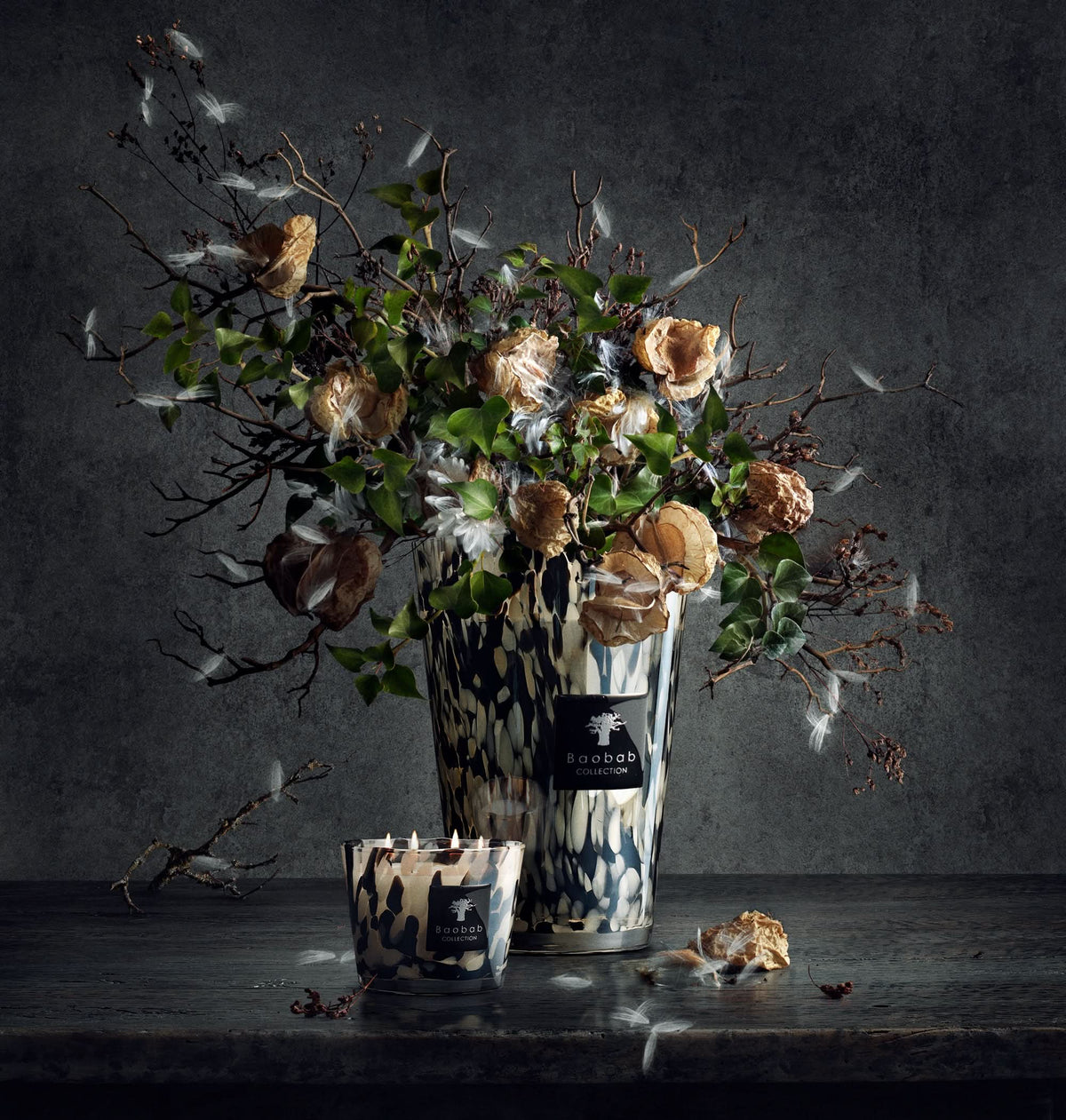 Scented candle display with leopard-print glass holder and dried florals in glass