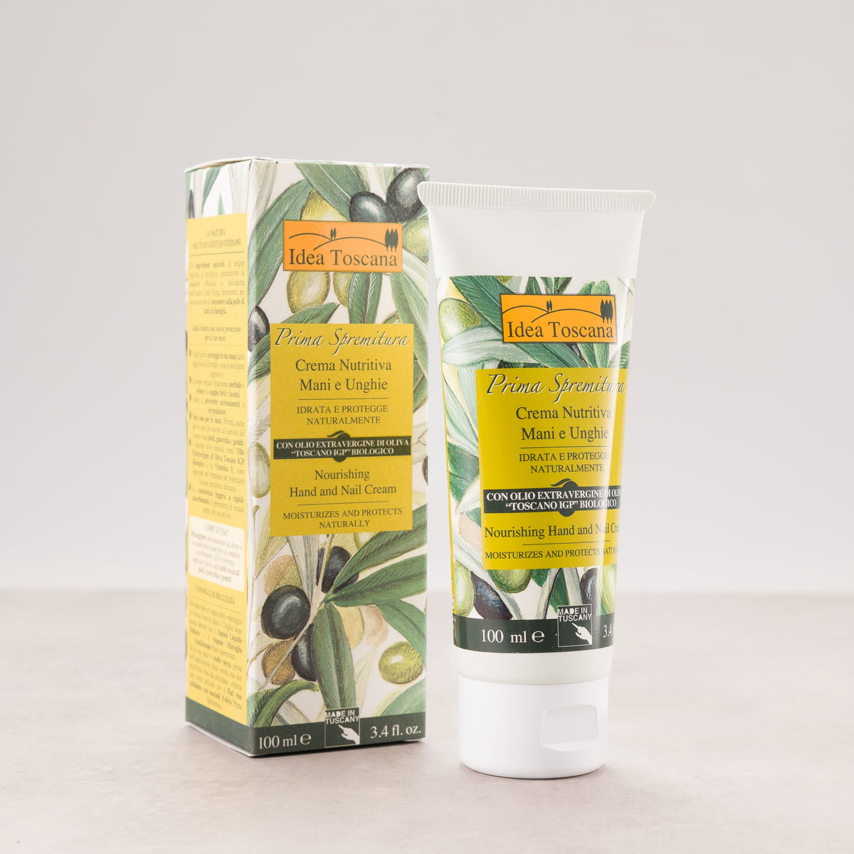Olive hand and nail cream tube beside matching carton box, 100 ml.