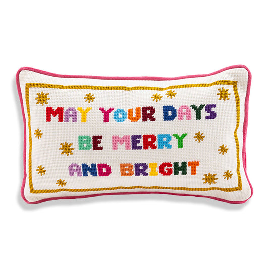 Needlepoint pillow reading 'May your days be merry and bright' with pink piping