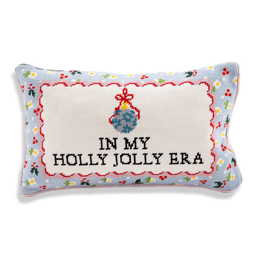 Rectangular needlepoint pillow with 'IN MY HOLLY JOLLY ERA' cross-stitch lettering