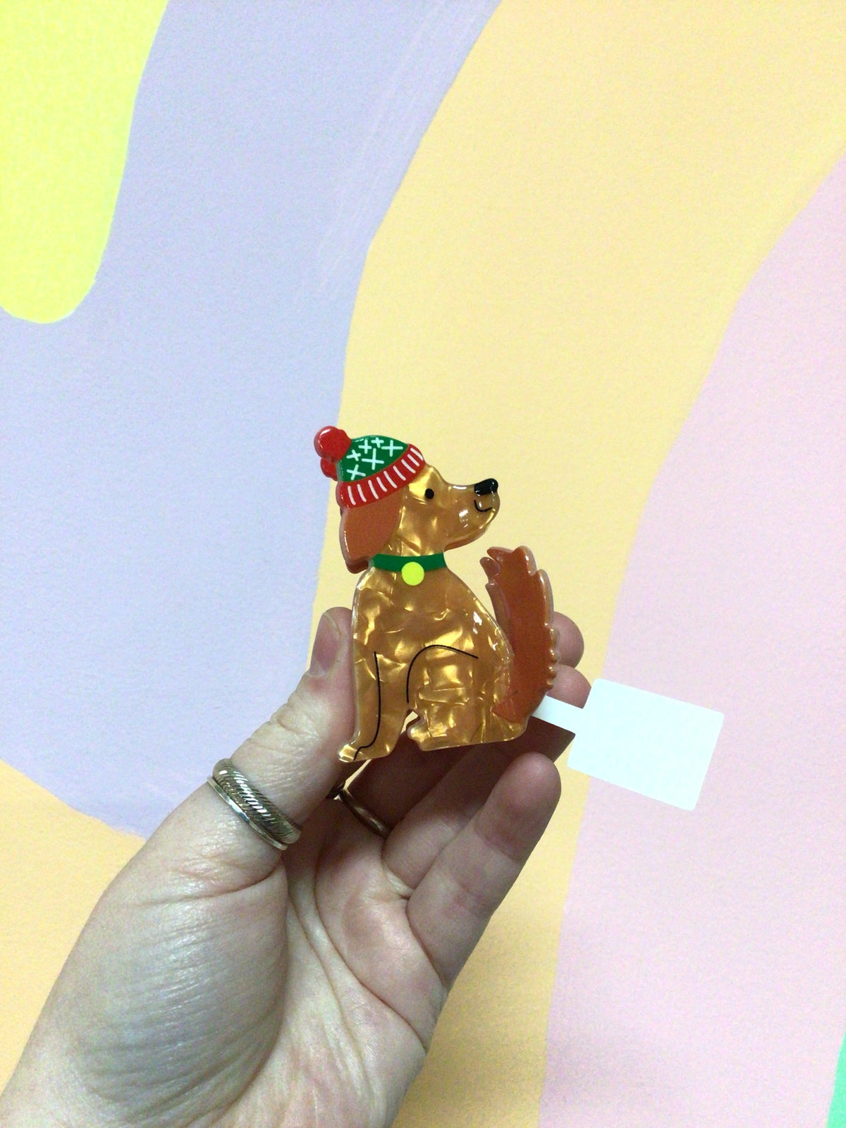 Gold dog hair claw with red-and-green festive hat decoration