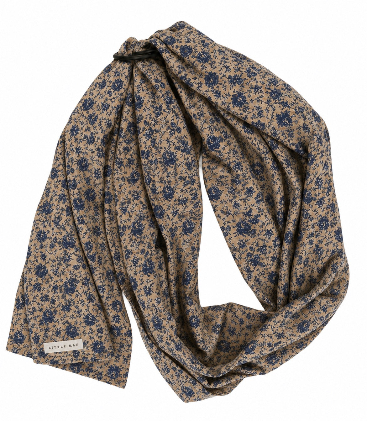 Ring sling baby carrier in tan fabric with a blue floral print and metal rings