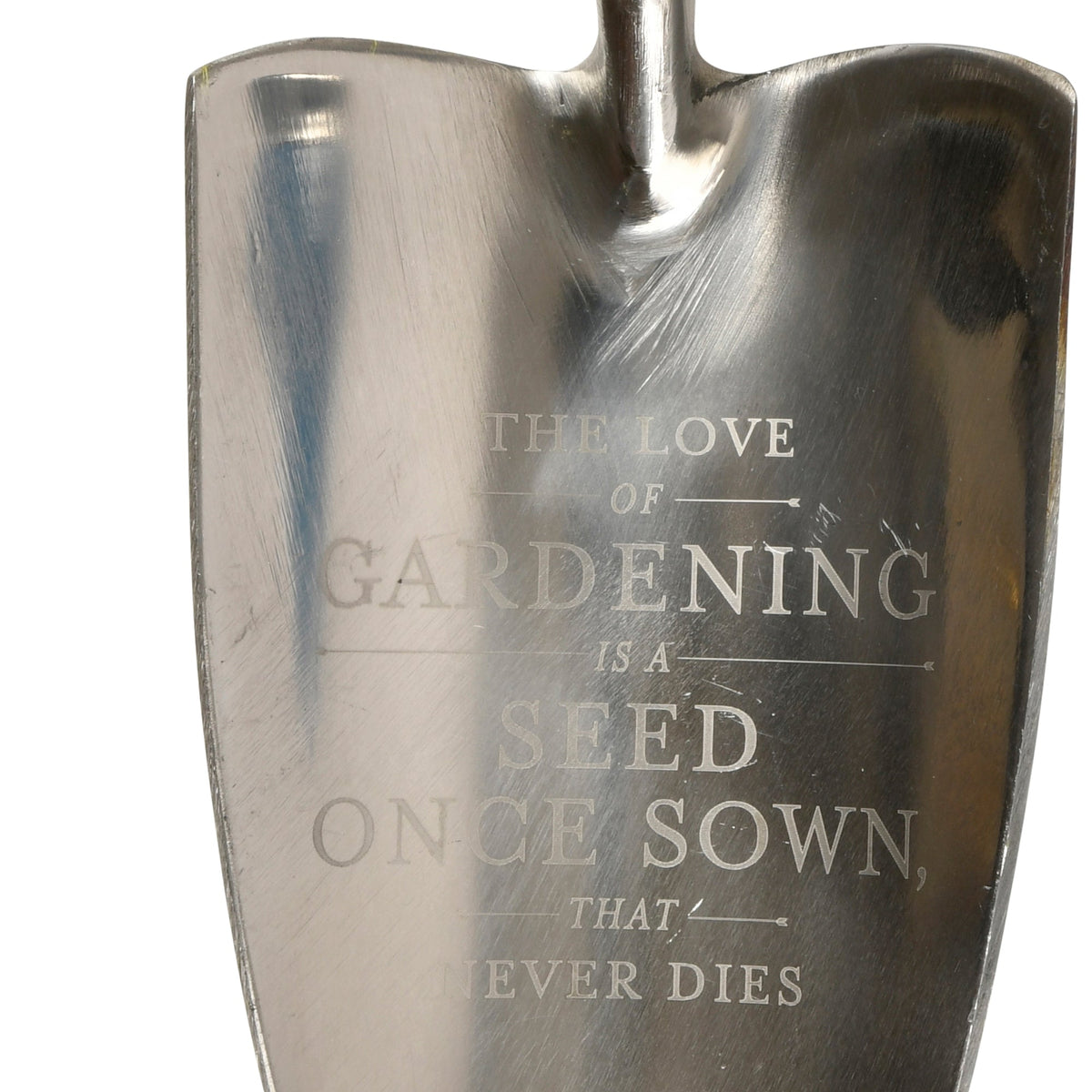 Stainless steel trowel blade close-up with engraved message on metal
