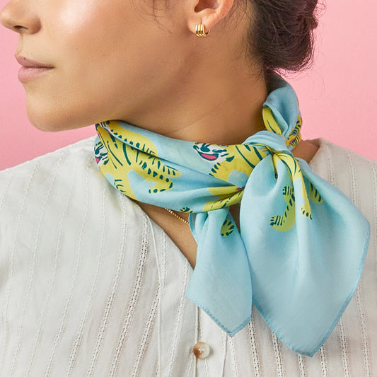 Blue tiger-print bandana tied at neck, with multicolor tiger faces.