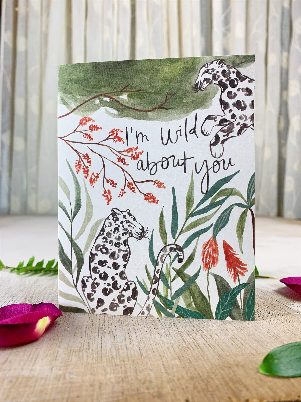 Jungle greeting card with kraft envelope, leopard print, tropical leaves, and 'I'm wild about you'.
