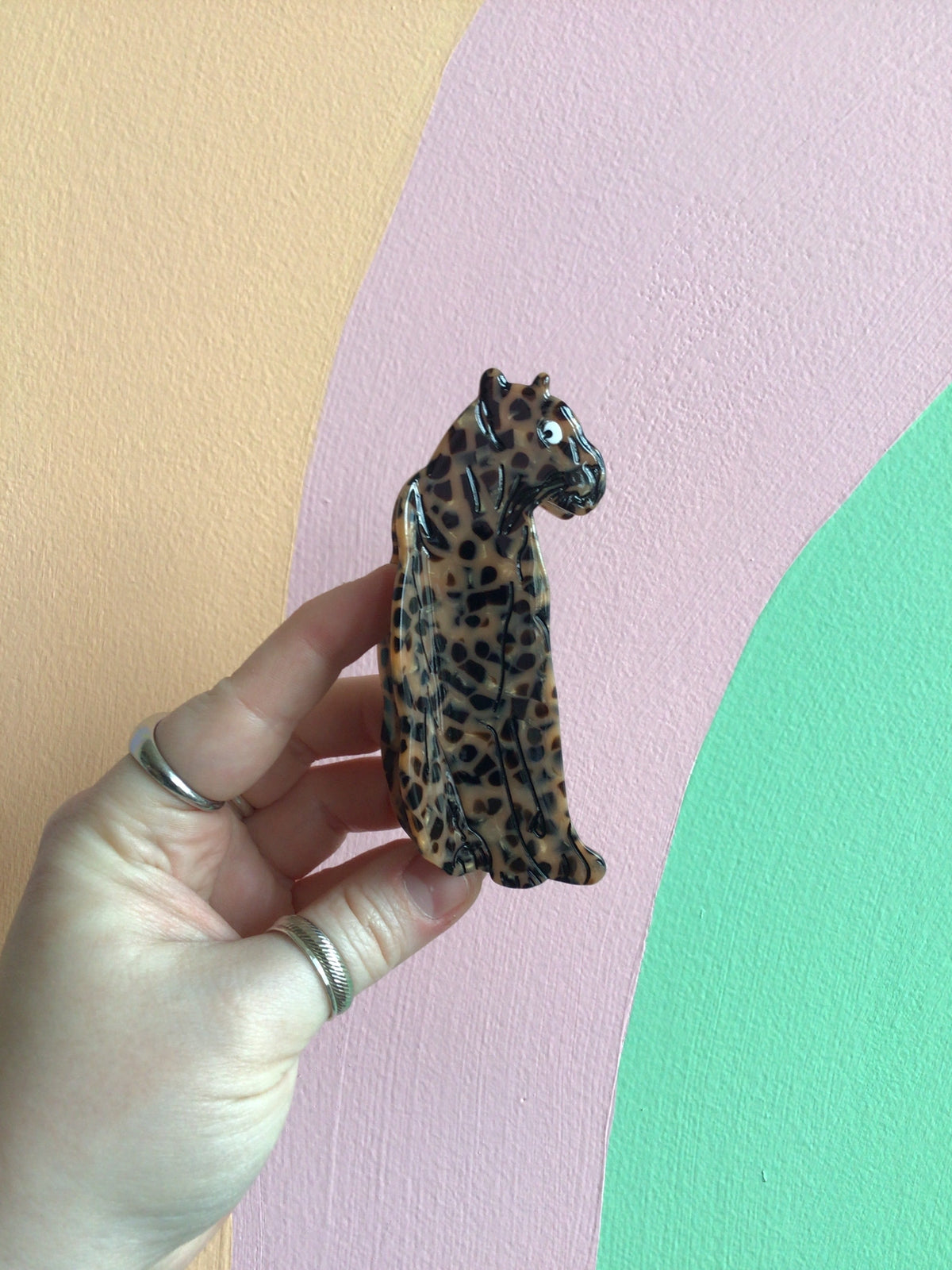 Jaguar-print hair claw figure with standing cat pose and dark spotted markings