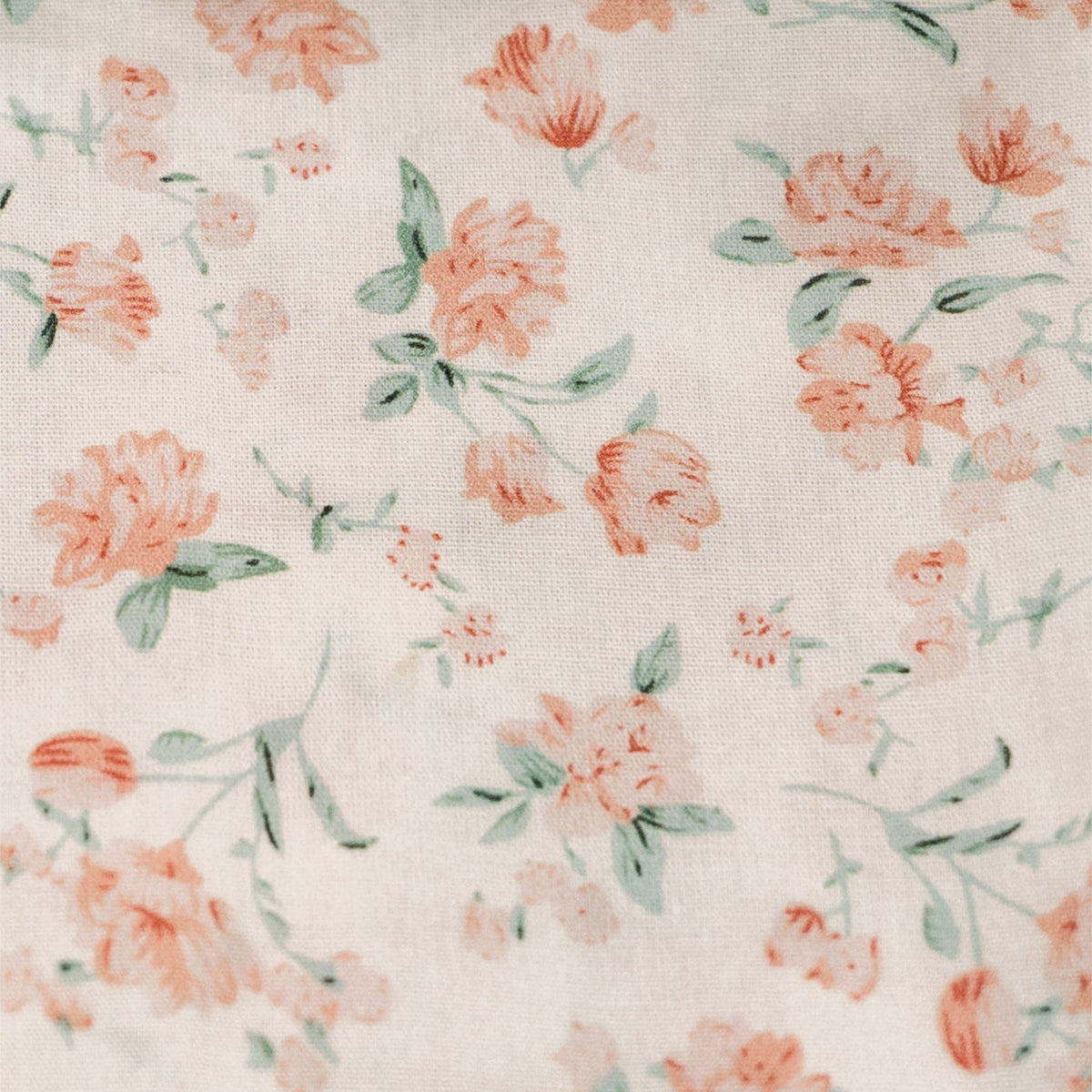 Floral fabric for zipper pouch, white base with orange and green flower prints.