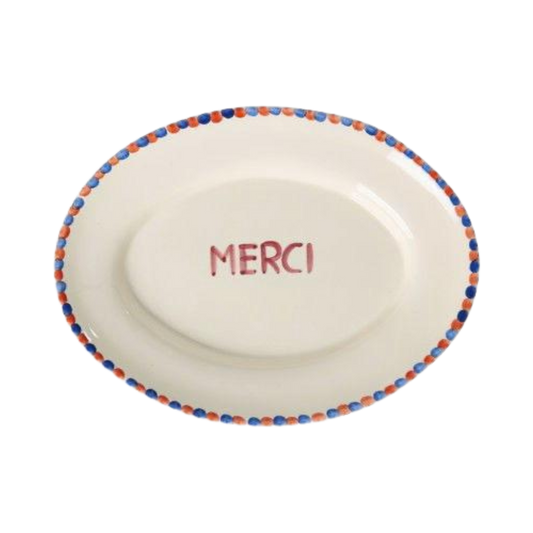 Ceramic serving platter with hand-painted MERCI and blue dot border rim, white base