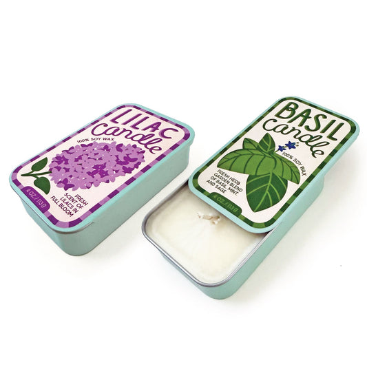 Soy wax candle tin with basil herb label, green leaves on pale mint lid.