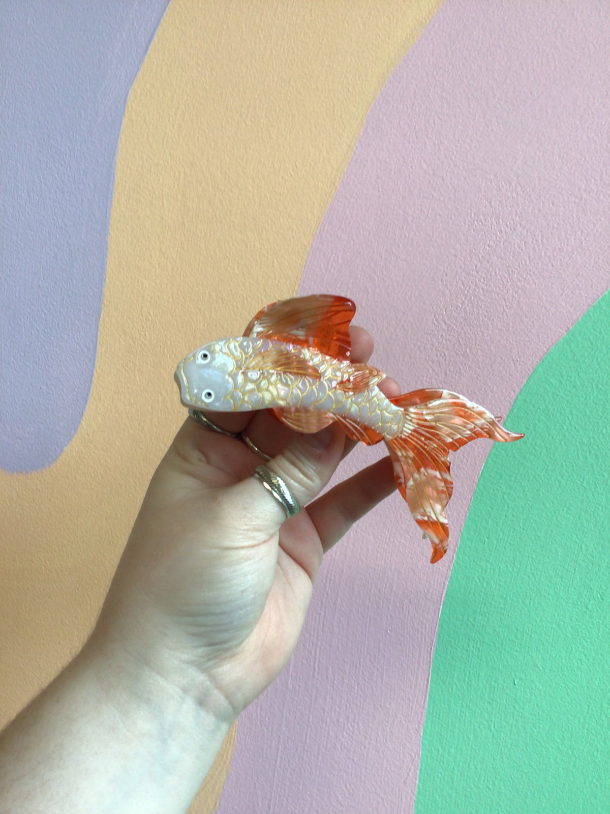 Koi fish hair claw with light blue body and orange fins