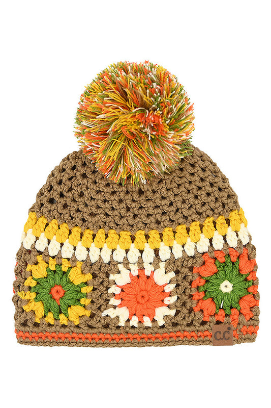 Handmade crochet beanie in dark camel with rainbow pom-pom and multicolor flower panels
