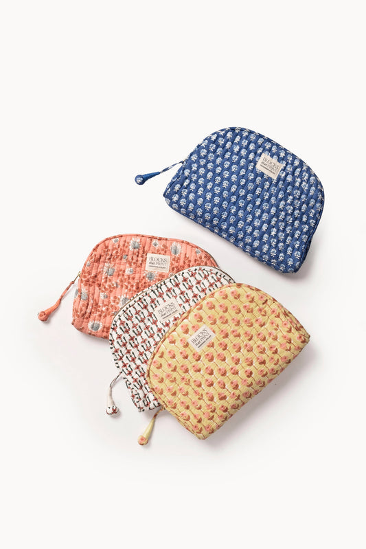 Quilted medium travel pouch set: blue, coral, and pale floral prints with zip tops.