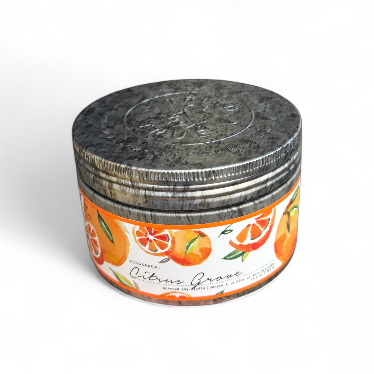 Round metal tin candle with orange and green citrus graphic label and silver top