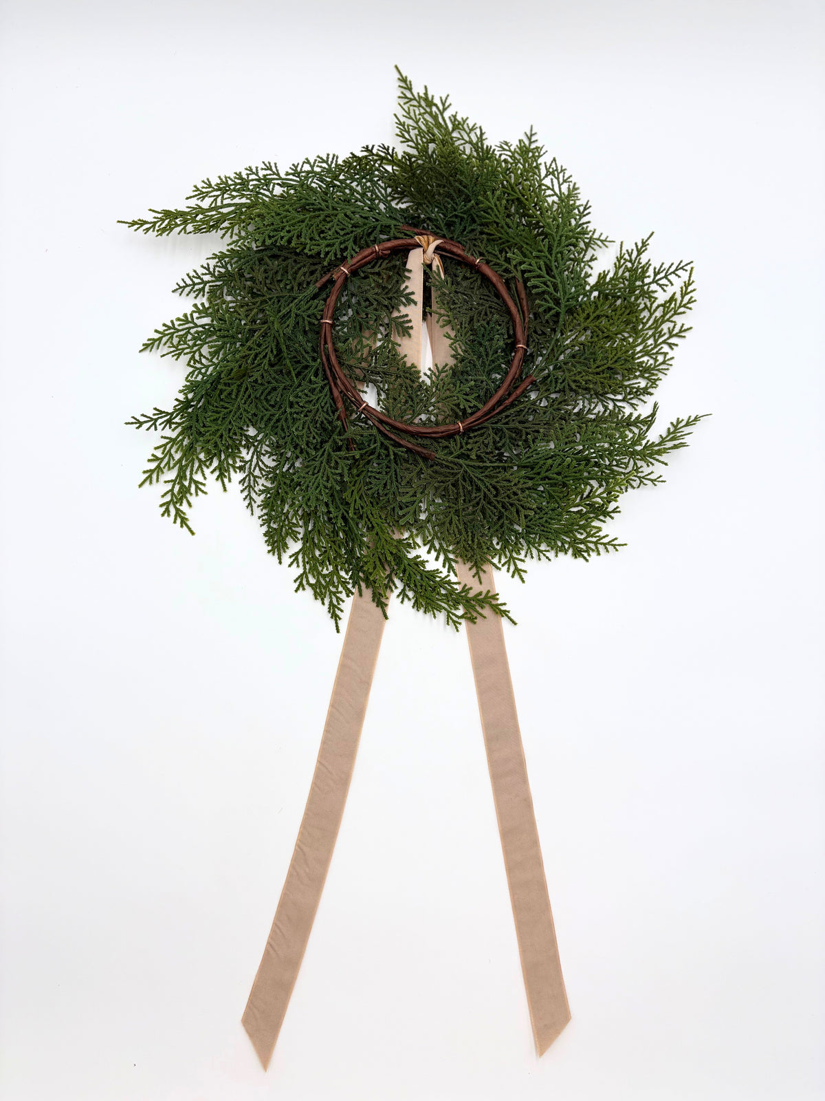 Mini cedar wreath with ribbon and a round ornament on the top loop