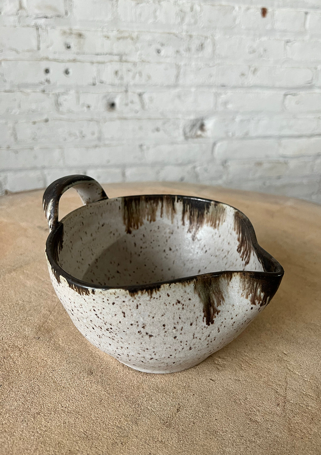White speckled stoneware batter bowl with loop handle, rustic glaze