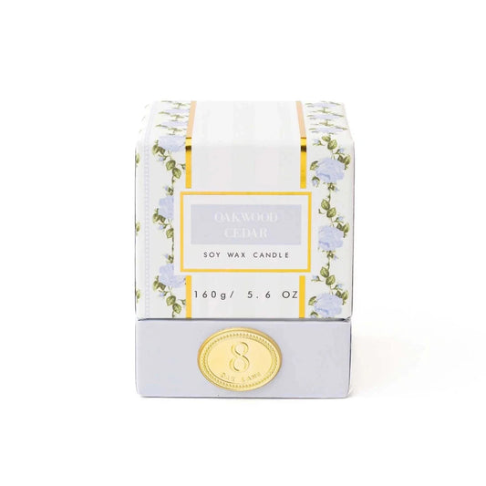 Boxed soy wax candle with Oakwood & Cedar label and gold flame-seal on front
