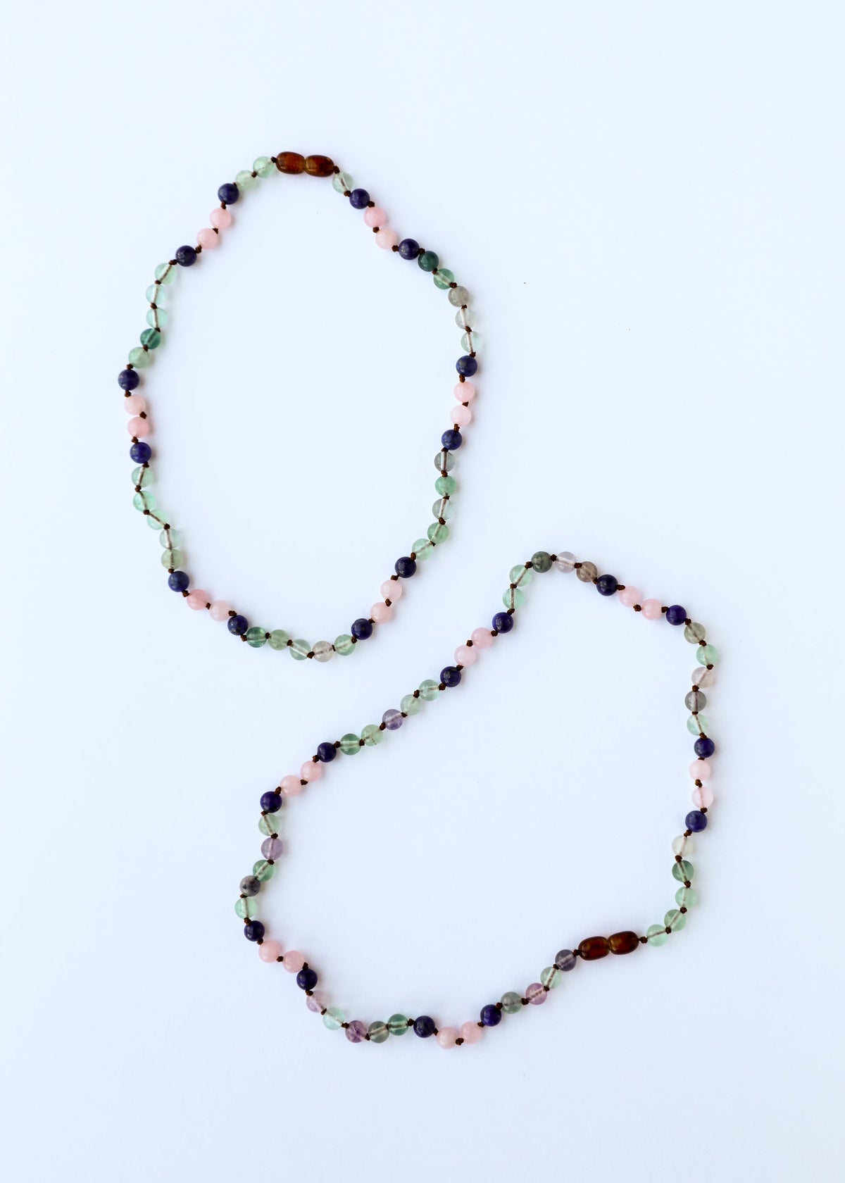 Gemstone bead necklace set, two oval strands with green, pink, navy, and amber beads