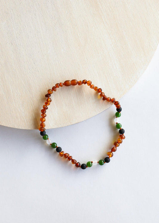 Beaded necklace strand with cognac amber orange, green and dark beads