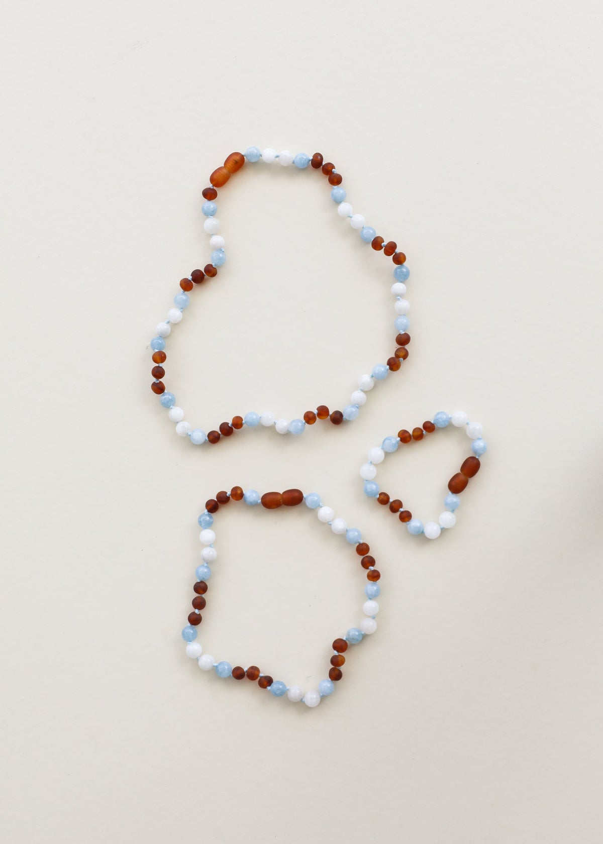 Gemstone beaded necklace with earrings, white and light blue with dark amber-brown beads