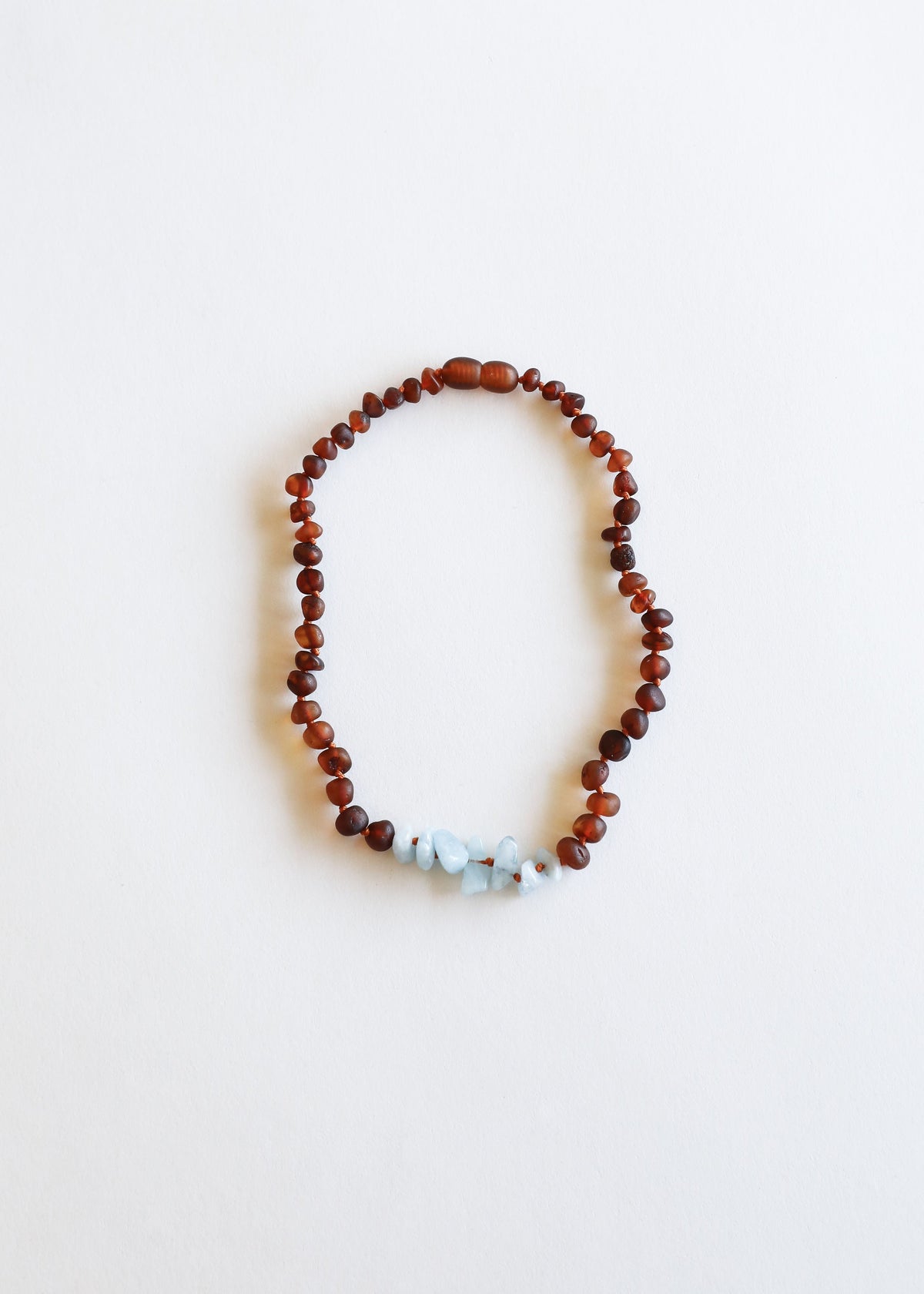 Raw amber bead necklace with pale blue stone center section