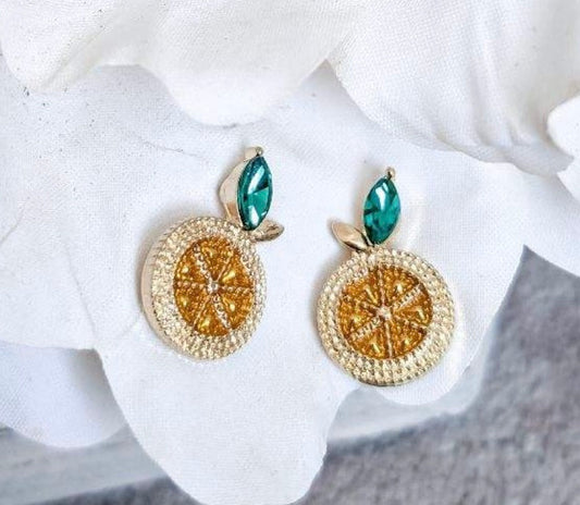 Pair of lemon stud earrings with gold textured round charms, teal center, and green leaf tops