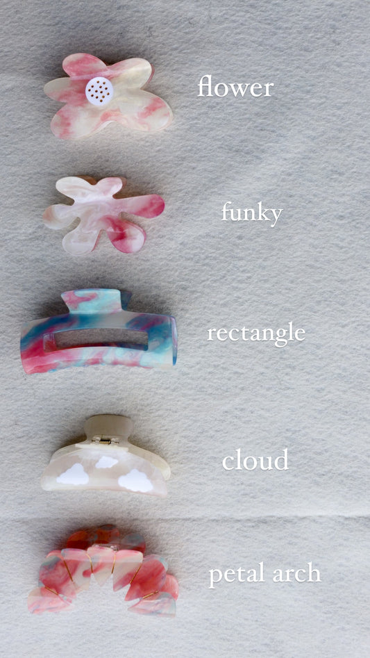 Color-changing translucent claw-shaped charms, pale pink, white, blue, and beige