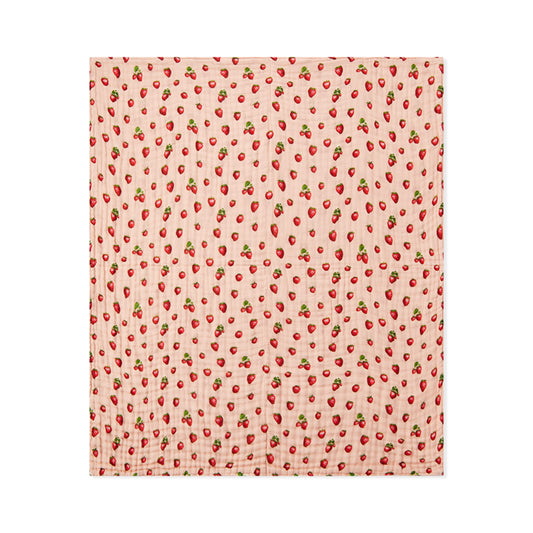 Peach strawberry print beach towel, square folded with repeating red berry pattern