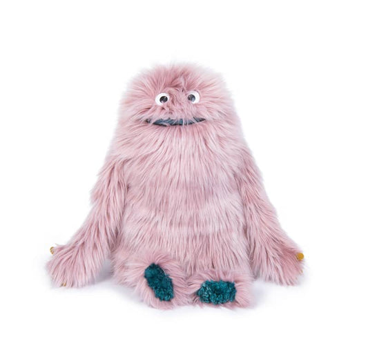Pink fuzzy stuffed monster toy with big eyes and teal hands and feet.