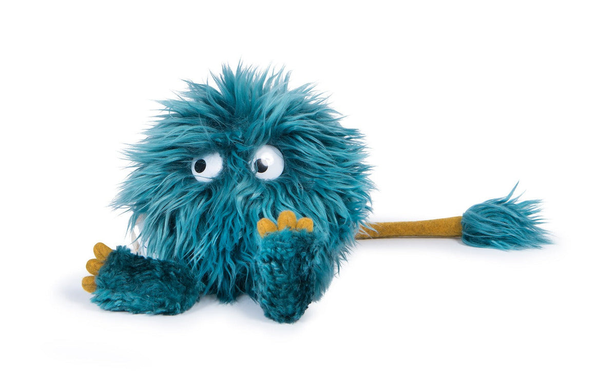 Choukette blue shaggy plush monster viewed from the other side, with yellow toes and a long tail