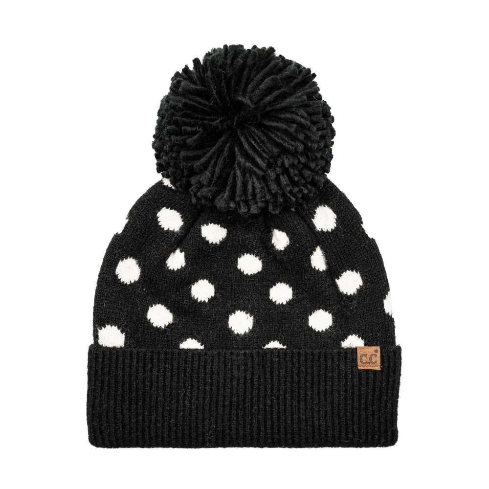 Polka dot knit beanie with black cuff, black pom, and white dots