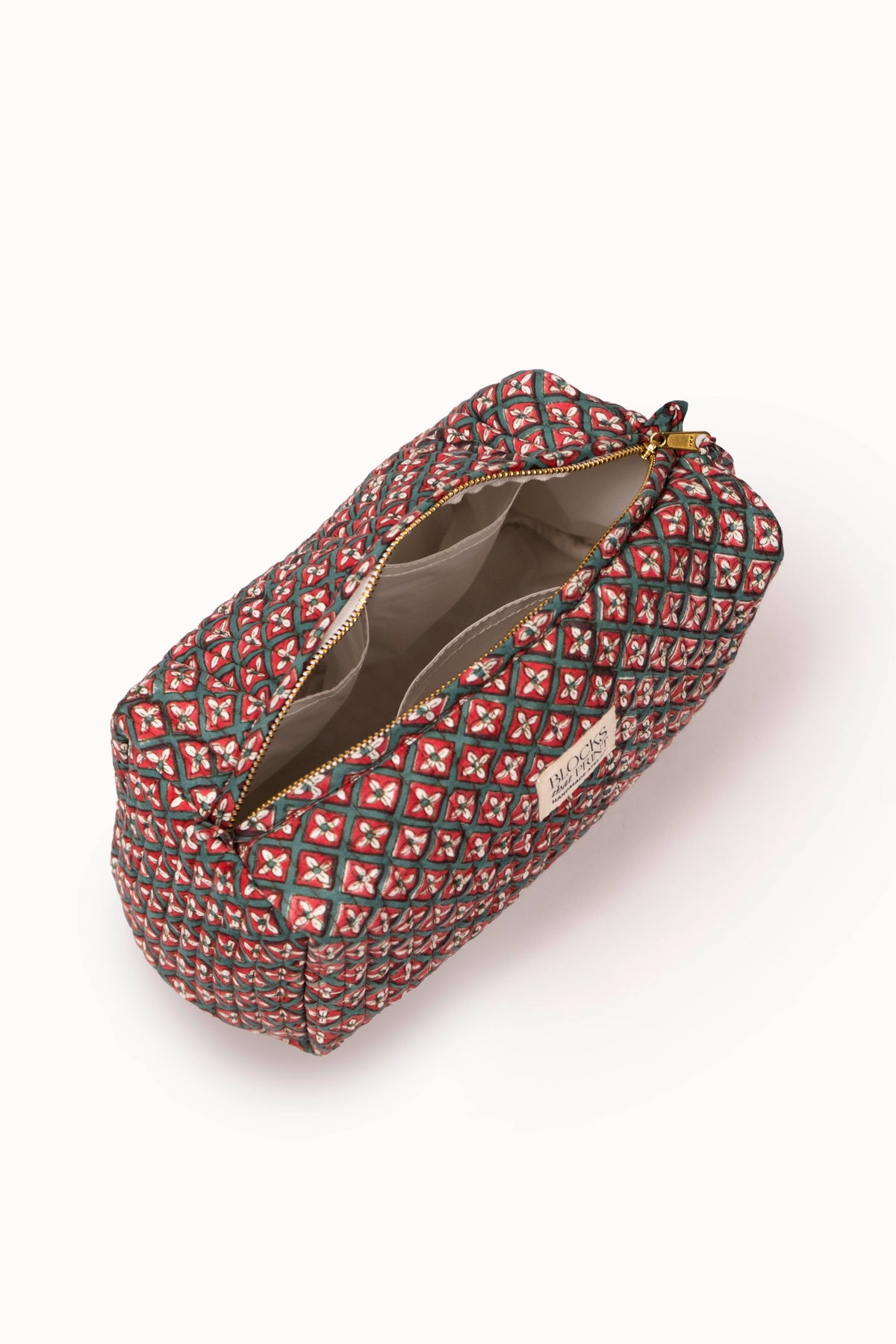 Quilted travel pouch with red diamond block print, open top showing fabric lining