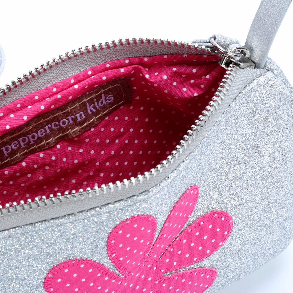 Silver glitter crossbody purse interior with pink polka-dot lining and zipper