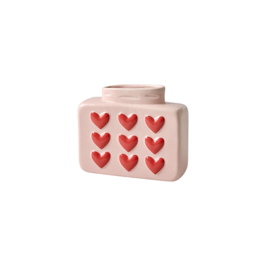 Light pink ceramic vase with embossed heart pattern, rounded top and square body