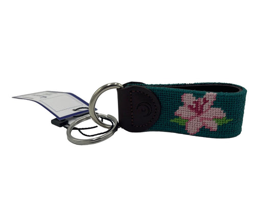 Green woven key fob with pink flower, brown leather tab, metal rings, hang tag
