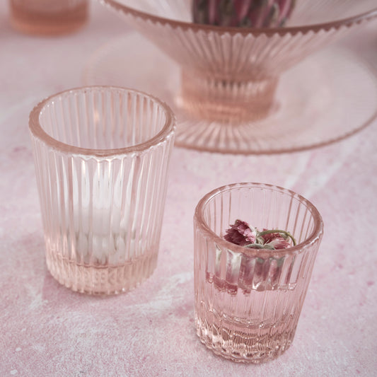 Pink pressed juice glasses, two ribbed tumblers with floral garnish inside
