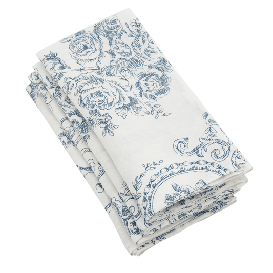 Set of 4 white linen napkins stacked with blue floral toile print