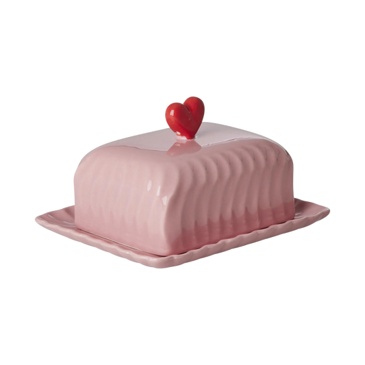 Pink ceramic butter dish with red heart finial and ridged dome lid