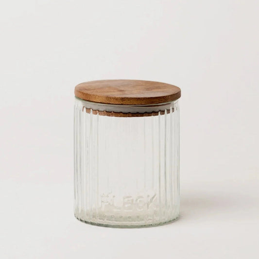 Fluted glass storage jar with wooden lid, embossed lettering on clear glass