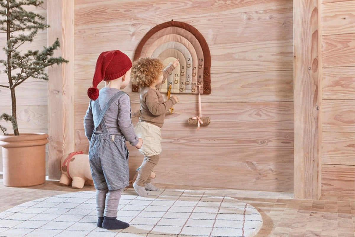 Rainbow arch advent calendar shown with numbered door pockets and hanging ornaments